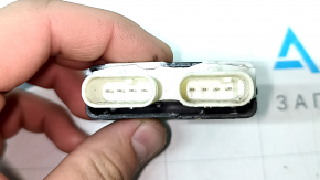 The control unit for opening the trunk with your foot on a Porsche Cayenne 19-26 has a broken housing.