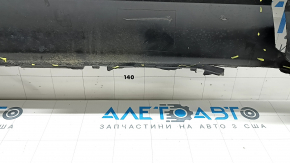 The rear bumper lip of a Porsche Cayenne 19-23, structured for parking sensors, Base, S, is broken, torn, scratched, and missing fragments.