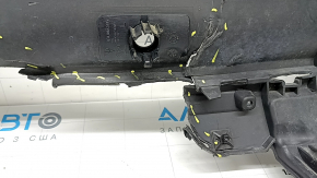 The rear bumper lip of a Porsche Cayenne 19-23, structured for parking sensors, Base, S, is broken, torn, scratched, and missing fragments.