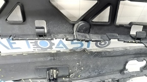 The rear bumper lip of a Porsche Cayenne 19-23, structured for parking sensors, Base, S, is broken, torn, scratched, and missing fragments.