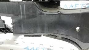 The rear bumper lip of a Porsche Cayenne 19-23, structured for parking sensors, Base, S, is broken, torn, scratched, and missing fragments.