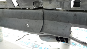 The rear bumper lip of a Porsche Cayenne 19-23, structured for parking sensors, Base, S, is broken, torn, scratched, and missing fragments.