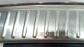 The trunk opening trim for a Porsche Cayenne 19-26 is black, with scratches and broken guides.