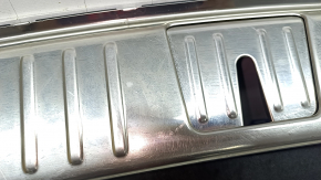 The trunk opening trim for a Porsche Cayenne 19-26 is black, with scratches and broken guides.
