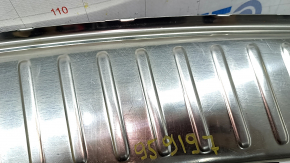 The trunk opening trim for a Porsche Cayenne 19-26 is black, with scratches and broken guides.