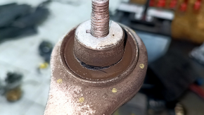 The upper front right control arm of a 19-26 Porsche Cayenne has a torn silent block.