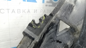 The front bumper guard, left, for a Porsche Cayenne 19-23, is dented and has tears.