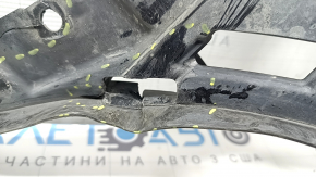 The front bumper guard, left, for a Porsche Cayenne 19-23, is dented and has tears.