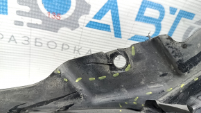 The front bumper guard, left, for a Porsche Cayenne 19-23, is dented and has tears.