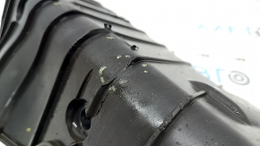 The rear right control arm lining under the spring of a Porsche Cayenne 19-26 has tears.