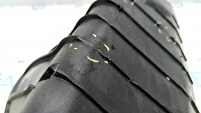 The rear left control arm lining under the spring of a Porsche Cayenne 19-26 has tears.