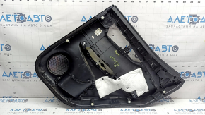 Rear left door panel for a 2022 Nissan Rogue Sport, black with black insert, black leather armrest, scratches