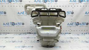 The bare heater housing of a 19-22 Nissan Rogue Sport without heated seats is broken.