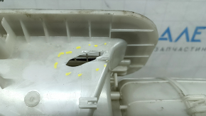 The bare heater housing of a 19-22 Nissan Rogue Sport without heated seats is broken.