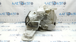 The bare heater housing of a 19-22 Nissan Rogue Sport without heated seats is broken.