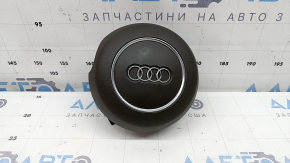 The steering wheel airbag for the driver's side of the Audi A6 C7 16-18 is brown and scratched.