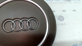 The steering wheel airbag for the driver's side of the Audi A6 C7 16-18 is brown and scratched.