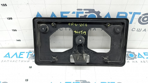 Honda CRV 20-22 front license plate area with scratches and cracks in the mountings