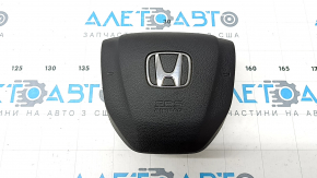 The Honda CRV 20-22 driver's steering wheel airbag is black and has a rusty squib.