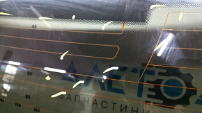 The rear window of an Audi A6 C7 12-18 has a broken heating wire, and is not factory tinted.