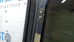 The rear window of an Audi A6 C7 12-18 has a broken heating wire, and is not factory tinted.
