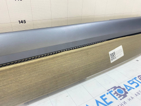 Tesla Model 3 18's upper dashboard trim panel - wood grain, veneer peeling off