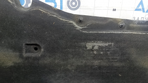 The left underbody protection of the Audi A6 C7 12-18 is torn and worn.