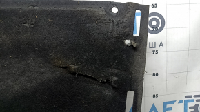 The left underbody protection of the Audi A6 C7 12-18 is torn and worn.