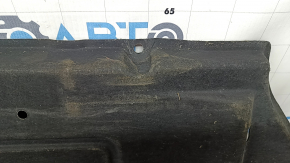 The right underbody protection of a Hyundai Tucson 22-26 is dented and the fastener is torn off.