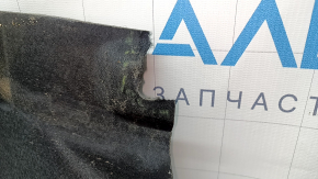 The right underbody protection of a Hyundai Tucson 22-26 is dented and the fastener is torn off.