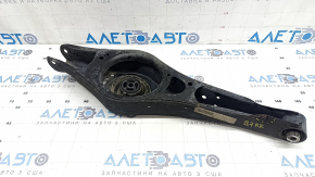 The lower control arm under the rear right spring of the VW Passat b7 12-15 USA is dented.