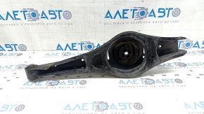 The lower control arm under the rear right spring of the VW Passat b7 12-15 USA is dented.