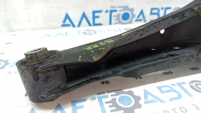The lower control arm under the rear right spring of the VW Passat b7 12-15 USA is dented.
