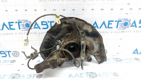 Front right axle hub for a Lexus ES300 ES330 with a cover and ABS sensor. The bearing is humming, the cover is dented, and it's rusty.