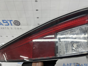 The right lower bumper light of a Toyota Prius 50 16-18 has dirty glass from the inside.
