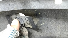 The bare lower rear bumper of a Volvo XC90 16-26 for parking sensors, white, the parking sensor mount is broken, dented, and there are cracks in the mounts.