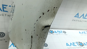 The bare lower rear bumper of a Volvo XC90 16-26 for parking sensors, white, the parking sensor mount is broken, dented, and there are cracks in the mounts.