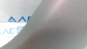 The lower right center pillar trim for a Toyota Prius V 15-17 is gray, worn, and the plastic has turned white.