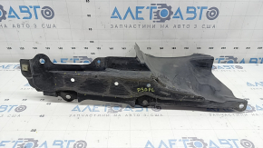 The left side engine protection of a Toyota Prius 50 16-18 is worn, torn, and dented.