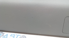 The lower trim of the trunk door of a Toyota Prius V 15-17 is gray, scratches, the plastic has turned white.