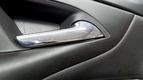 The front right door panel of the Chevrolet Volt 16 is black, with a black leather insert, the armrest is black leather, with a handle, without a cover and buttons, scratches