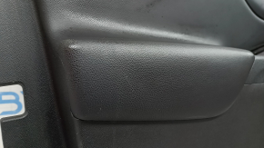 The front left door panel of a Chevrolet Volt 16 is black, with a black leather insert, the armrest is black leather, with a handle, without a trim and buttons, scratches