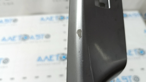 The rear right door window control panel for a Toyota Prius V 12-17 is gray and has some wear and scratches.