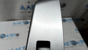 The rear right door window control panel for a Toyota Prius V 12-17 is gray and has some wear and scratches.