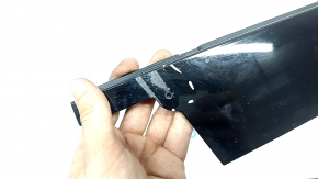 The front left side door trim for a Porsche Macan 15-26 is worn.