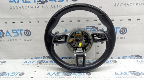The steering wheel is bare, leather, black, heated, with buttons, paddles, and overlays, and has scratches.
