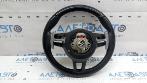 The steering wheel is bare, leather, black, heated, with buttons, paddles, and overlays, and has scratches.