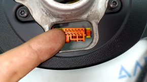 The steering wheel is bare, leather, black, heated, with buttons, paddles, and overlays, and has scratches.