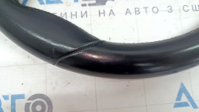 The steering wheel is bare, leather, black, heated, with buttons, paddles, and overlays, and has scratches.