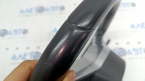 The steering wheel is bare, leather, black, heated, with buttons, paddles, and overlays, and has scratches.